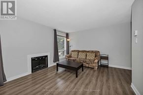 Ottawa townhouse for rent - A living room with a fireplace and a couch.