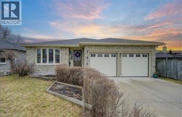 Waterloo apartment for rent - A house with a garage and a small garden in front.