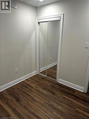 Waterloo apartment for rent - A room with a white door and wood flooring.