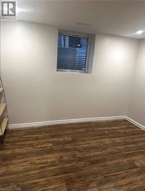 Waterloo apartment for rent - A room with wooden flooring and a window with blinds.