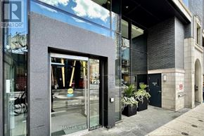Toronto (Waterfront Communities) condo for rent - A building with a glass door and a sign that says "125" on it.
