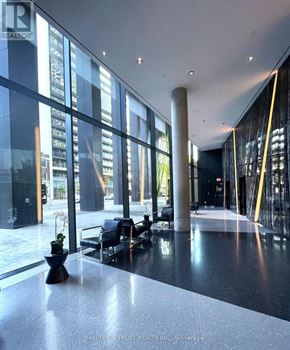 Toronto (Waterfront Communities) condo for rent - A lobby with a black and white floor and a large window.