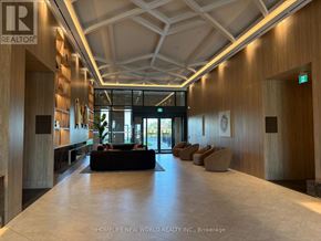 Vaughan (Vaughan Corporate Centre) condo for rent - A spacious lobby with a reception desk and seating area.