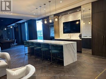 Vaughan (Vaughan Corporate Centre) condo for rent - A modern living room with a large TV and a long table with chairs.