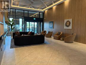 Vaughan (Vaughan Corporate Centre) condo for rent - A spacious waiting area with a black couch and two chairs.