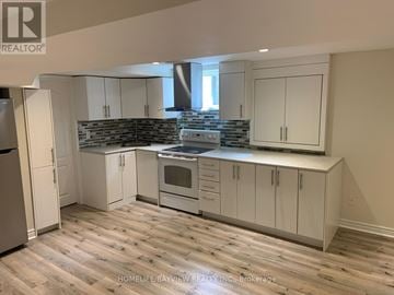 Richmond Hill (Westbrook) apartment for rent - A kitchen with white cabinets and a wooden floor.