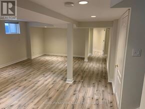 Richmond Hill (Westbrook) apartment for rent - A spacious room with wooden flooring and white walls.
