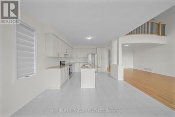 Loyalist (Bath) apartment for rent - A spacious kitchen with white cabinets and a wooden floor.