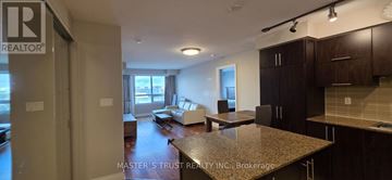 Markham (Unionville) condo for rent - A kitchen area with a granite countertop and cabinets.