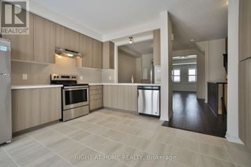 Brampton (Bram West) townhouse for rent - A modern kitchen with wooden cabinets and a tile floor.