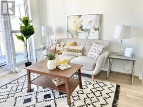Toronto (Henry Farm) condo for rent - A living room with a couch, a coffee table, and a rug.