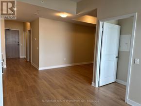 Vaughan (Concord) condo for rent - A room with wooden flooring and a white door.