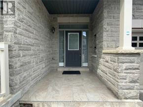 Vaughan (Vellore Village) townhouse for rent - A stone house entrance with a black door and a doormat.