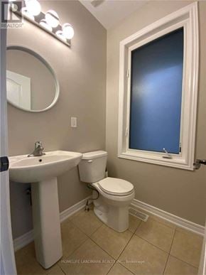 Vaughan (Vellore Village) townhouse for rent - A bathroom with a sink, toilet and mirror.