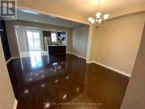 Vaughan (Vellore Village) townhouse for rent - A large empty room with wood flooring and a chandelier.