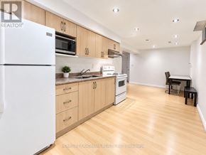 Markham (Raymerville) apartment for rent - A kitchen with wooden floors and white appliances.