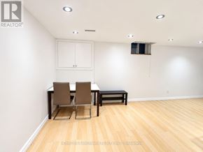Markham (Raymerville) apartment for rent - A room with a table and chairs and a cabinet.