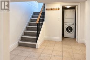 Aurora (Aurora Highlands) apartment for rent - A hallway with a staircase and a washing machine in the doorway.