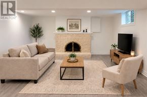 Aurora (Aurora Highlands) apartment for rent - A living room with a couch, a chair, and a fireplace.
