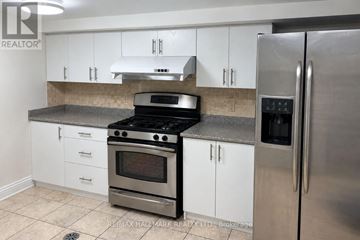 Aurora (Aurora Highlands) apartment for rent - A kitchen with white cabinets and a stainless steel refrigerator.