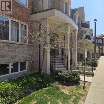 Oakville (Wm Westmount) townhouse for rent - A building with a balcony and a tree in front of it.