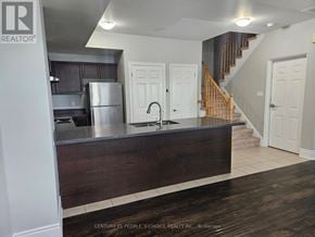 Oakville (Wm Westmount) townhouse for rent - A kitchen with a wooden counter and a refrigerator.