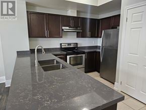 Oakville (Wm Westmount) townhouse for rent - A kitchen with a granite countertop and stainless steel appliances.