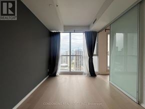 Toronto (Bay Street Corridor) condo for rent - A spacious room with a view of the city through the window.