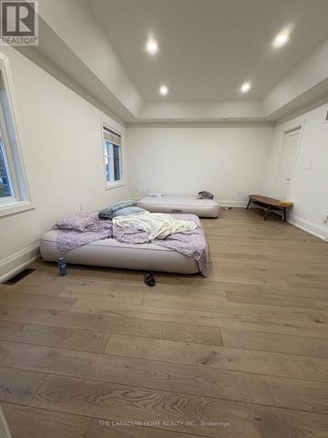 Brampton (Northwest Brampton) apartment for rent - A bedroom with a bed and a bench in it.
