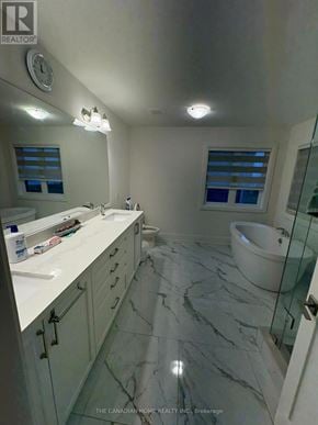 Brampton (Northwest Brampton) apartment for rent - A bathroom with a marble floor and white countertops.