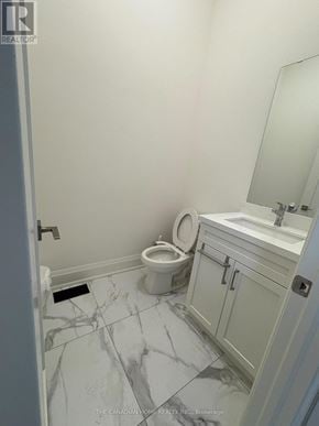 Brampton (Northwest Brampton) apartment for rent - A white bathroom with a marble floor and a white toilet.