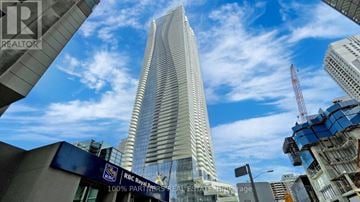 Toronto (Church-Yonge Corridor) condo for rent - A tall skyscraper with a blue sky in the background.
