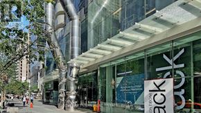 Toronto (Church-Yonge Corridor) condo for rent - A modern building with a glass facade and a sign that reads "back.".