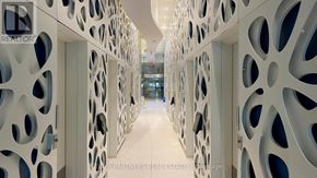 Toronto (Church-Yonge Corridor) condo for rent - A hallway with a white wall and a pattern of holes.