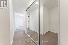 Toronto (Forest Hill South) condo for rent - A hallway with a glass door and a white wall.