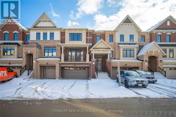 Markham (Victoria Square) townhouse for rent - A large, multi-story residential building with a parking lot in front.