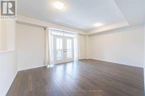 Markham (Victoria Square) townhouse for rent - A room with wooden floors and a sliding glass door.