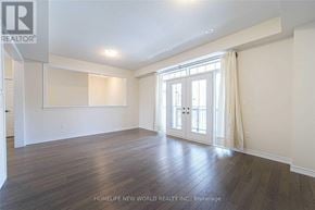 Markham (Victoria Square) townhouse for rent - A room with wooden floors and a sliding glass door.