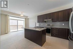 Markham (Victoria Square) townhouse for rent - A kitchen with dark brown cabinets and a marble countertop.