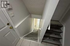 Brampton (Snelgrove) apartment for rent - A stairway with a white door at the bottom.