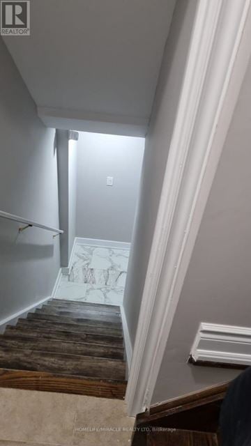 Brampton (Credit Valley) apartment for rent - A stairway with a wooden floor and white walls.