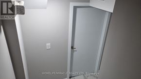 Brampton (Credit Valley) apartment for rent - A white door in a room with a light switch on the wall.