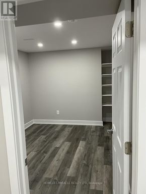 Brampton (Credit Valley) apartment for rent - A room with wooden flooring and white walls.