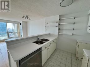 Toronto (Waterfront Communities) condo for rent - A kitchen with white cabinets and a black dishwasher.