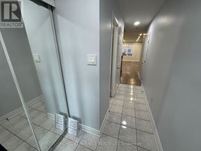 Mississauga (Lisgar) townhouse for rent - A hallway with a sign that says "HOMELIT-MIRACLE REALTY LTD, Brokerage" on the floor.
