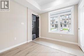 Guelph (Kortright East) townhouse for rent - A room with a large window and a door leading to another room.