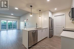 Clearview (Creemore) condo for rent - A kitchen with white cabinets and a stainless steel refrigerator.