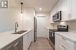 Clearview (Creemore) condo for rent - A kitchen with white cabinets and stainless steel appliances.