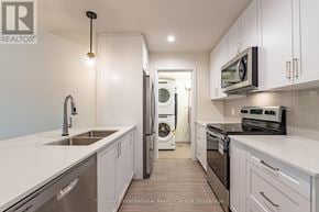 Clearview (Creemore) condo for rent - A modern kitchen with white cabinets and stainless steel appliances.