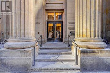 Toronto (Church-Yonge Corridor) condo for rent - The front steps of a building with a large entrance and two large columns on either side.